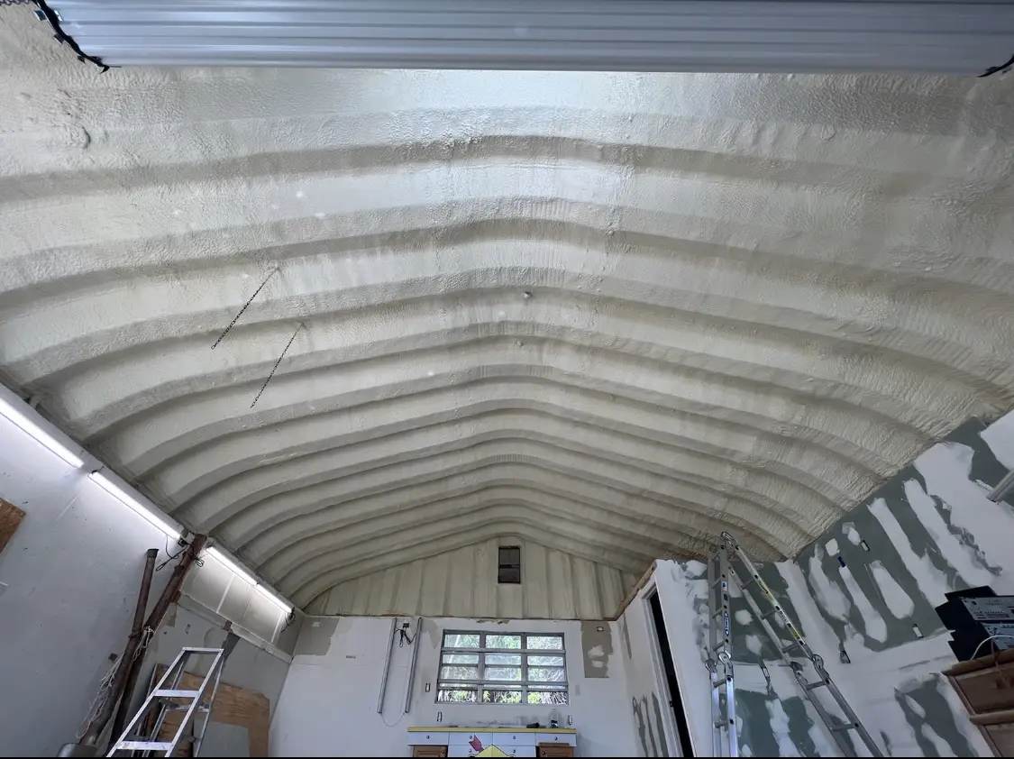 Spray polyurethane foam applied to the underside of a metal roof deck in Galion